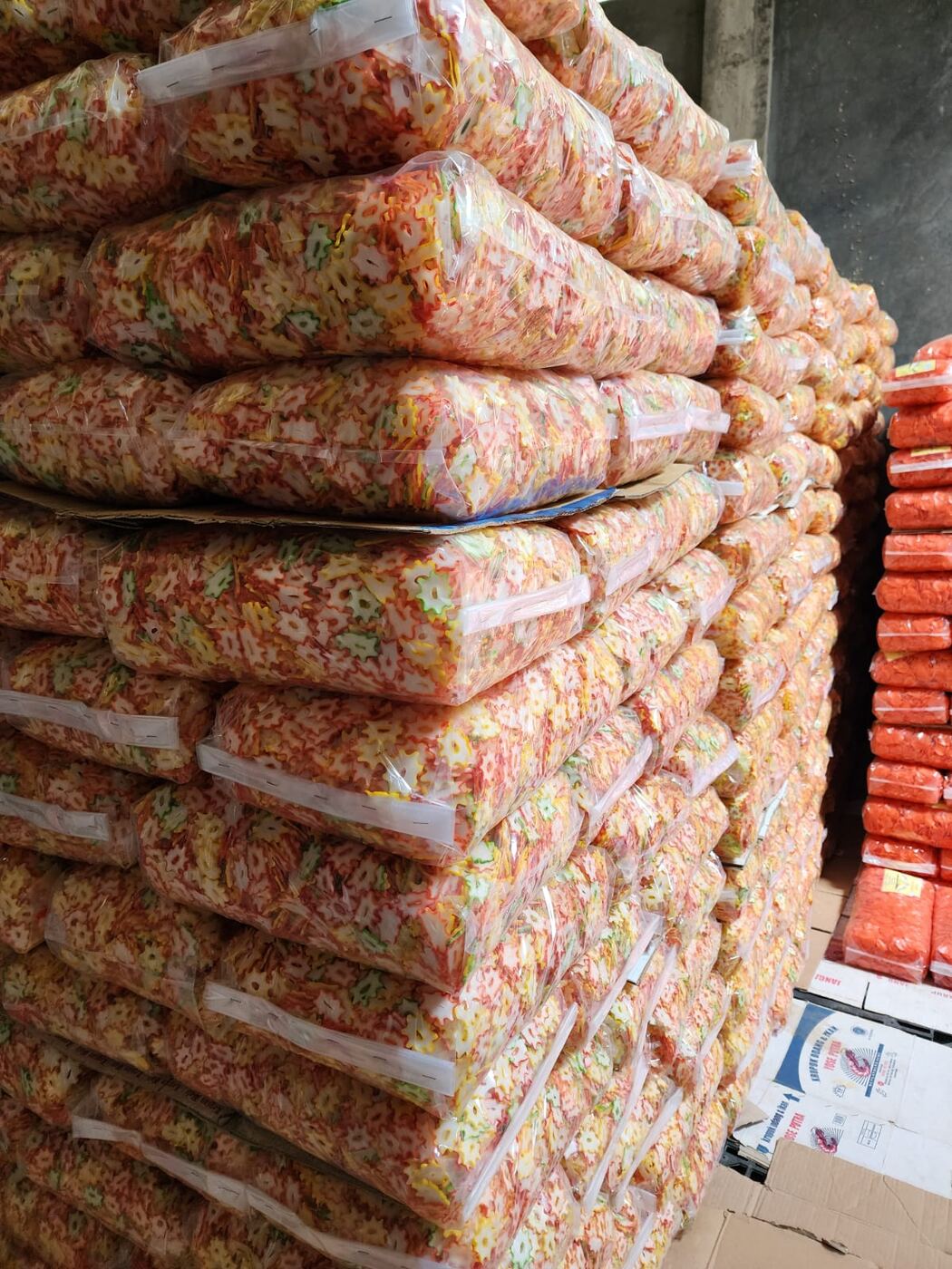 Close-up of colorful packaged Indonesian crackers ready for shipment